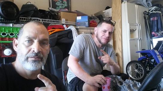 Two friends relax indoors, engaging in conversation and enjoying each other's company.