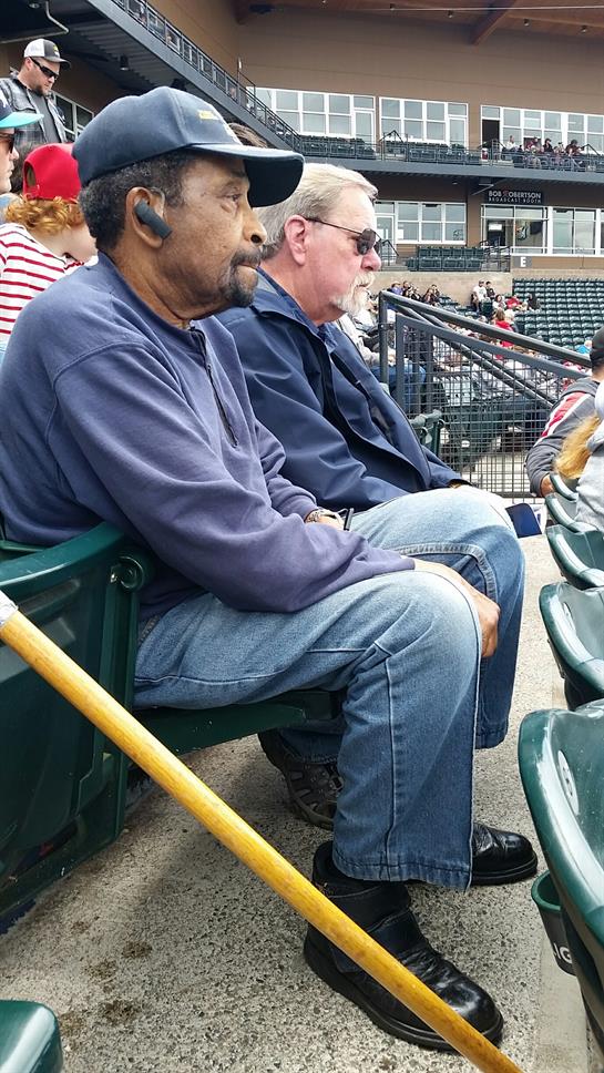 Fans relax and watch the game in a bustling stadium, soaking up the lively atmosphere.