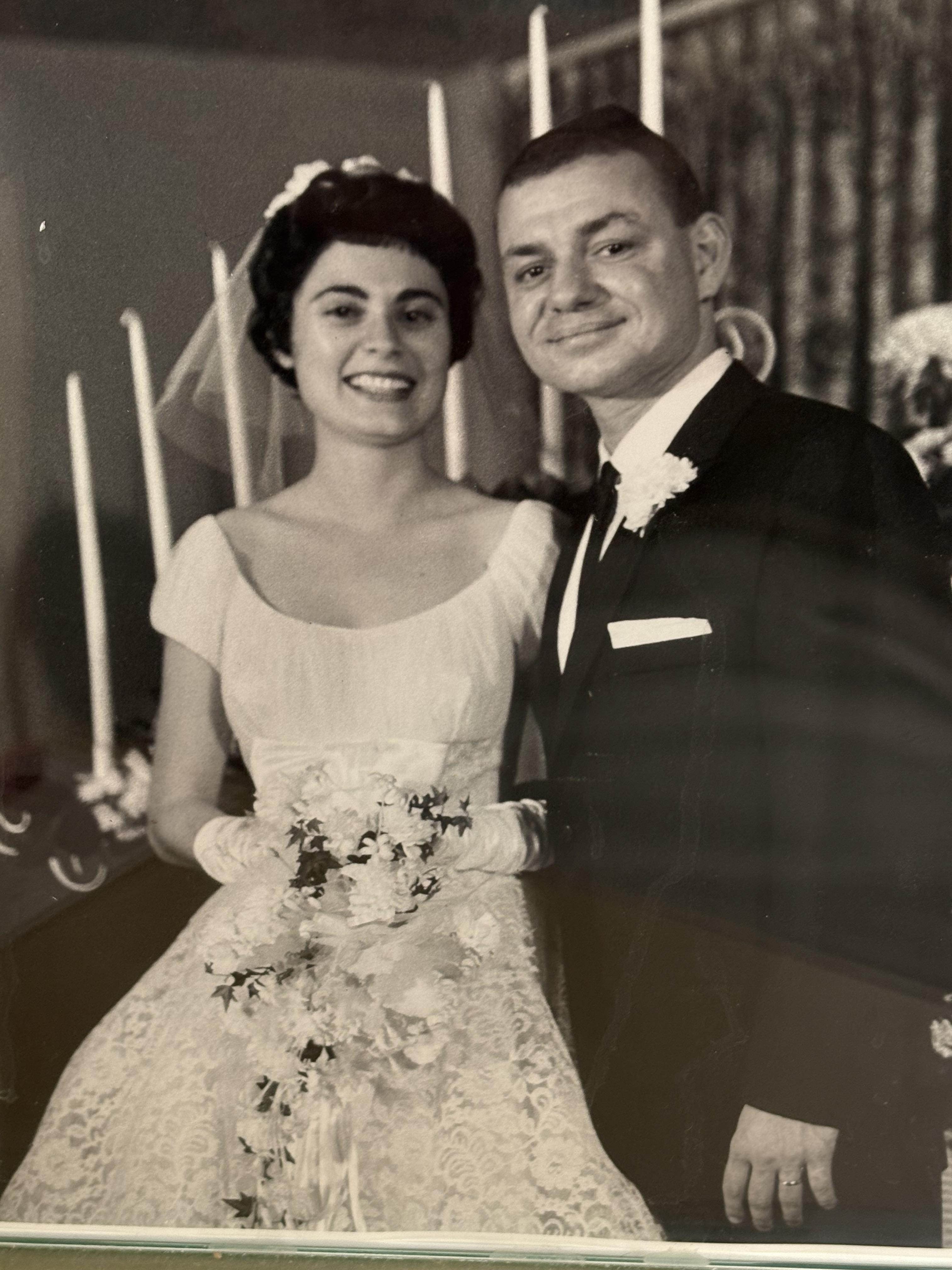 Bride and groom pose happily together, showcasing love and joy on their special day.