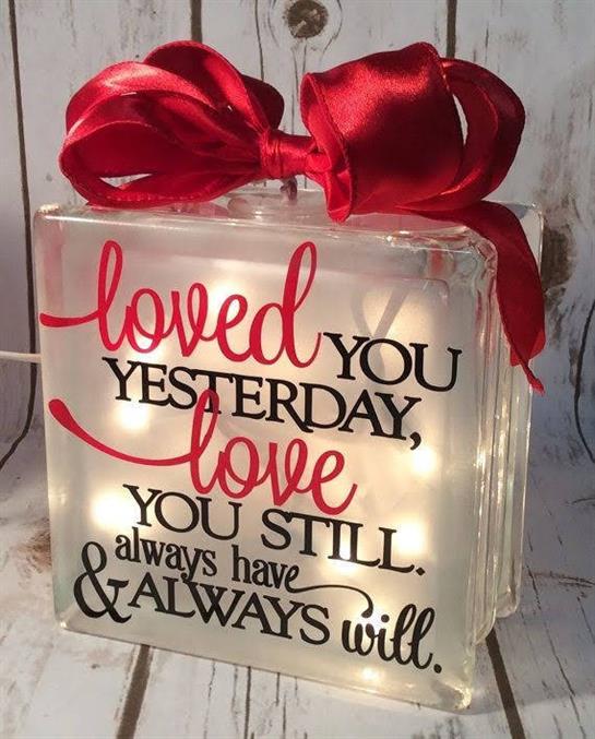 A glass block radiates a warm message of enduring love, enhancing home ambiance.