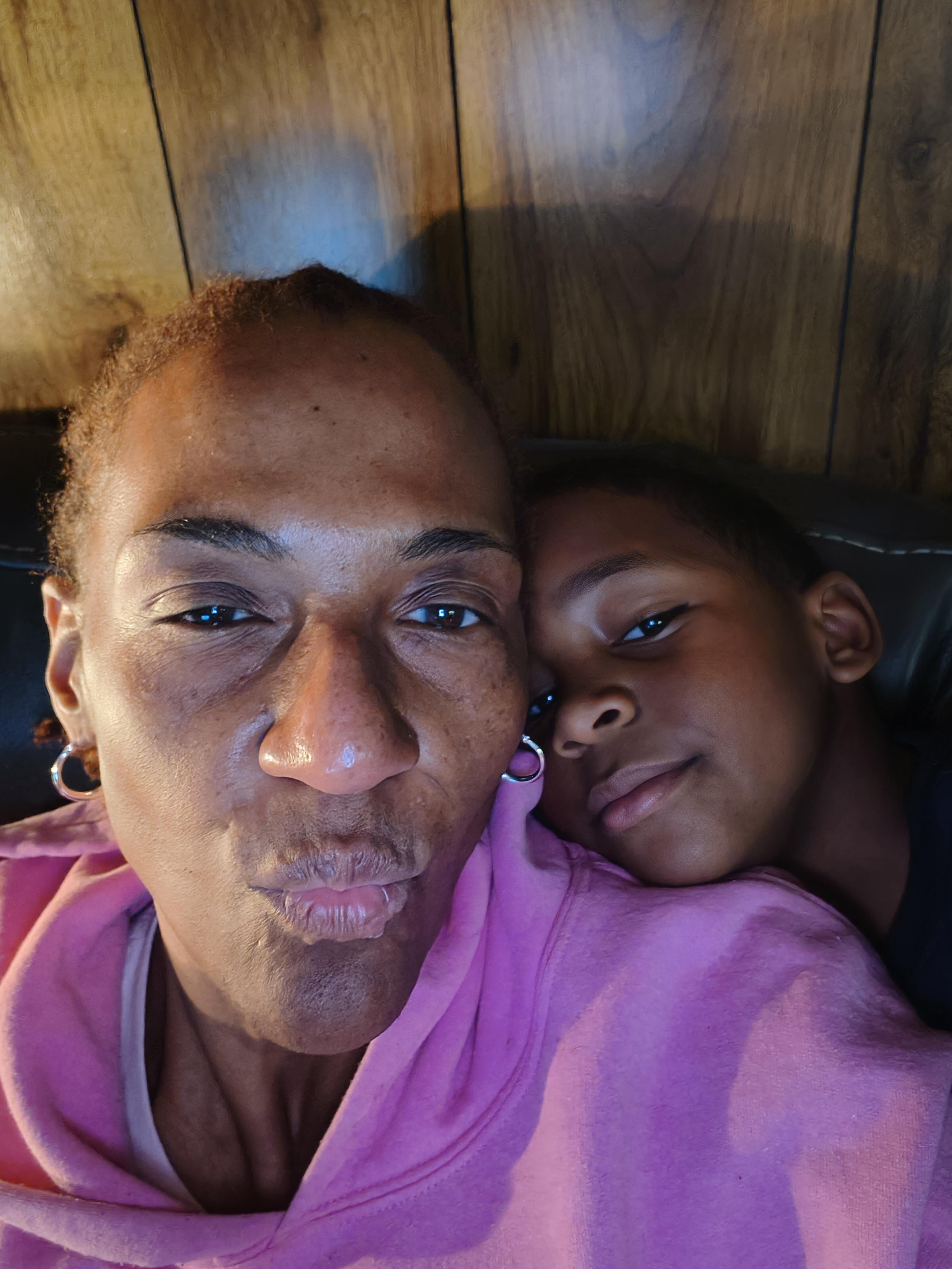 A woman and a boy taking a selfie
