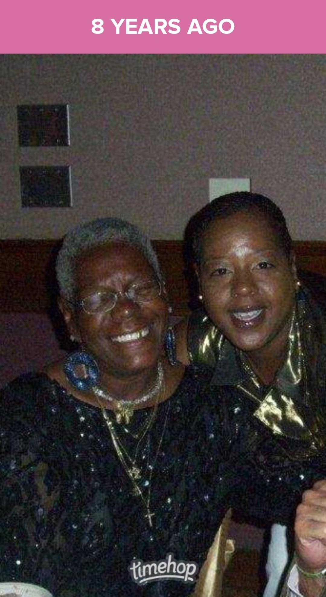 Two joyful women pose closely together, showcasing their happiness at a social celebration.