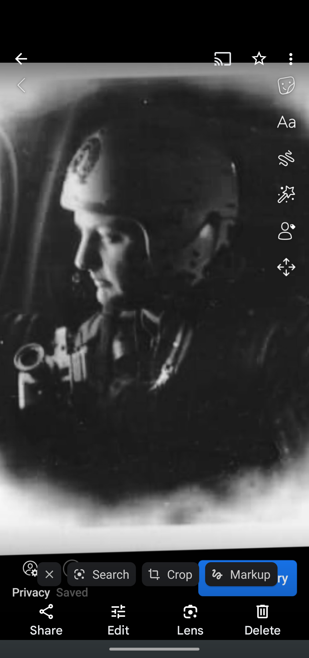A soldier sits in a military aircraft, focused and ready for an upcoming mission.