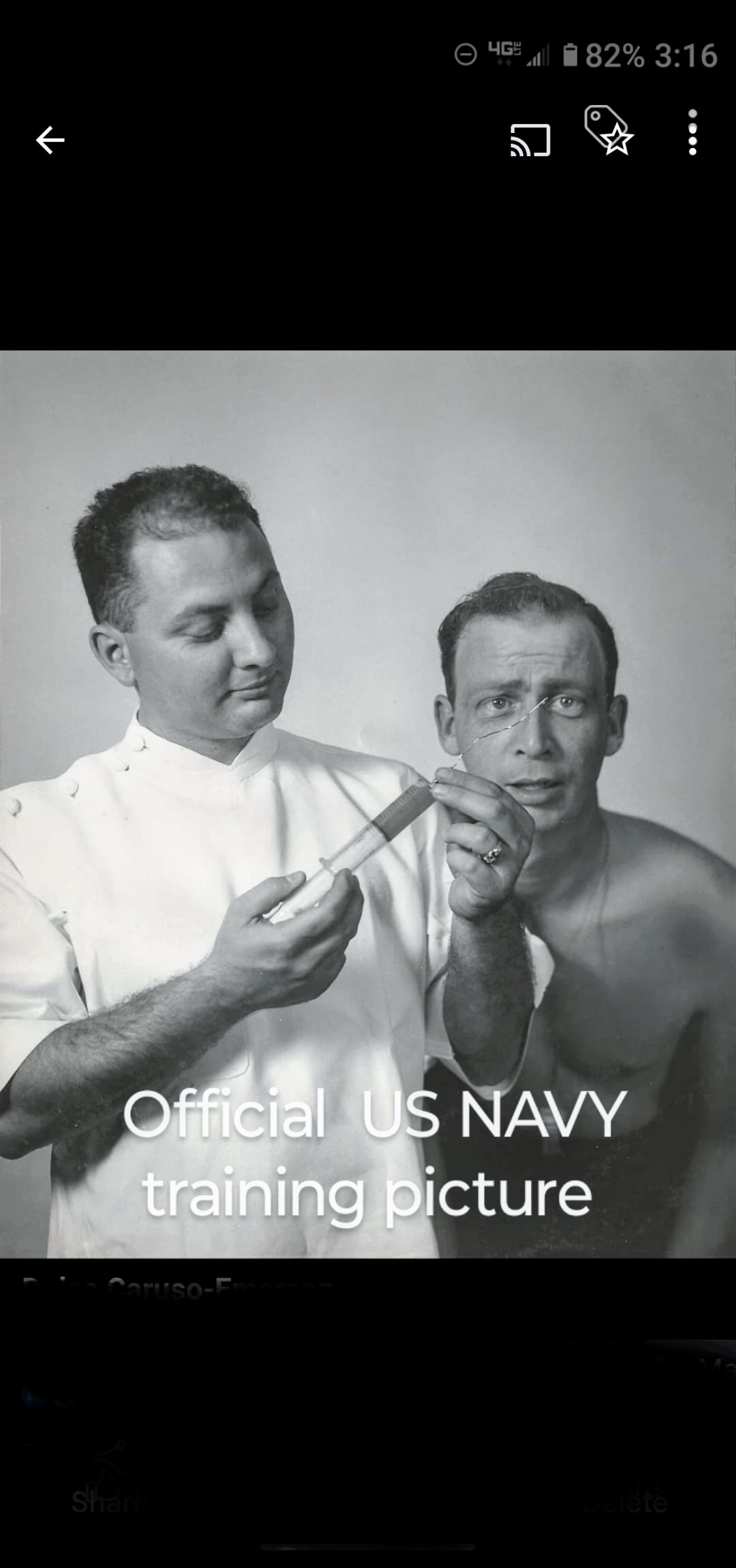 Two men participate in a medical training exercise, focusing on a medical tool used in examinations.