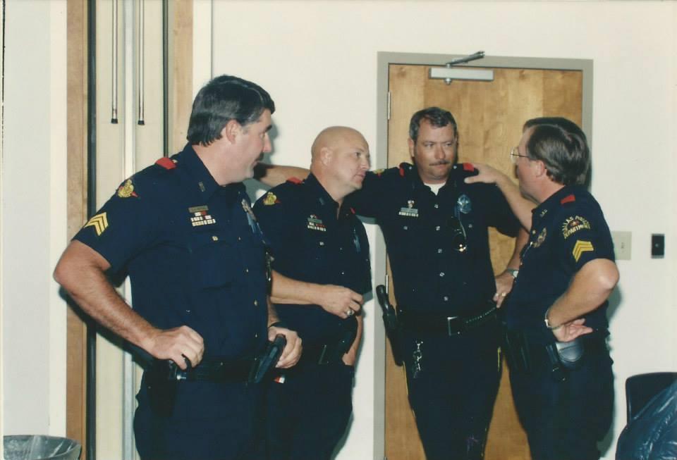 Four officers engage in conversation while planning strategies in a meeting room.
