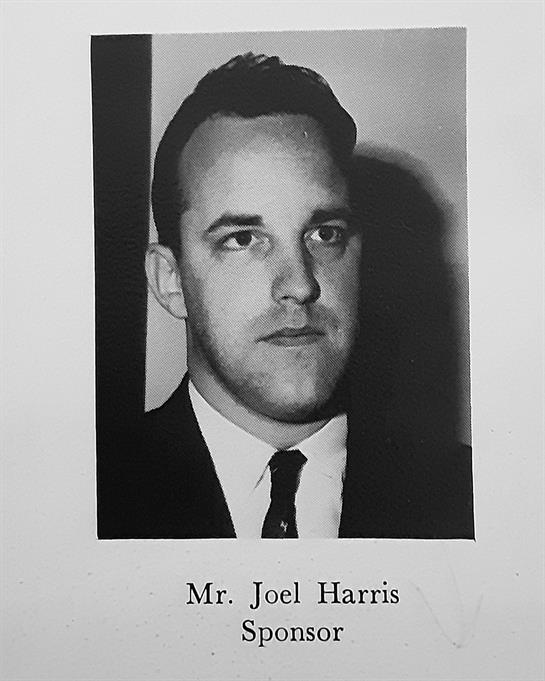 A formal black and white portrait of a man with a serious expression, wearing a suit.