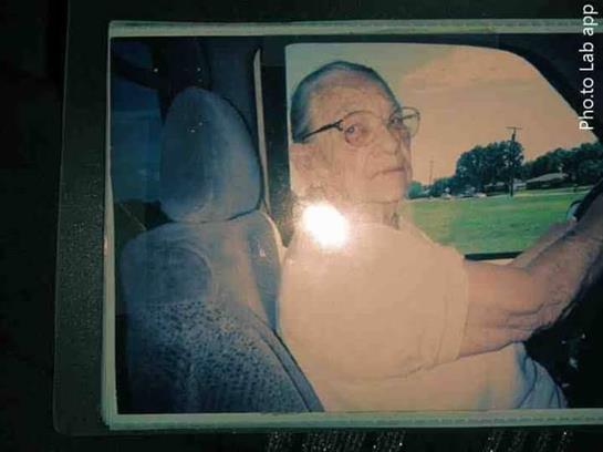 An older gentleman drives a car, displaying a peaceful demeanor while enjoying the view.