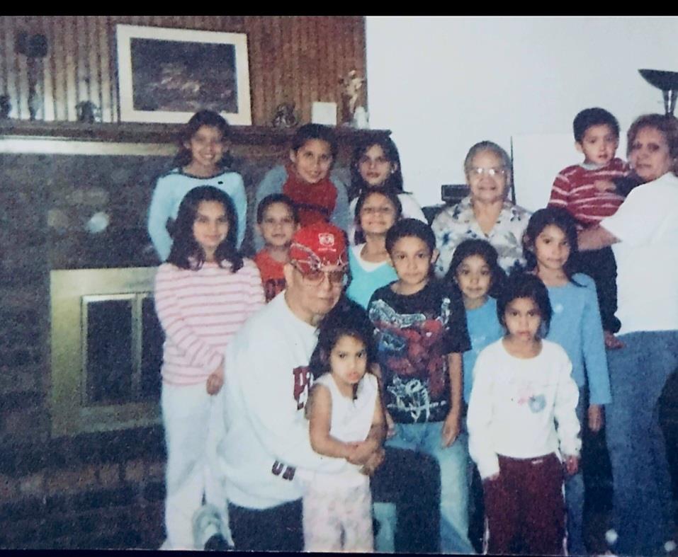 Kids and adults gather in a cozy living room, smiling and enjoying time together.