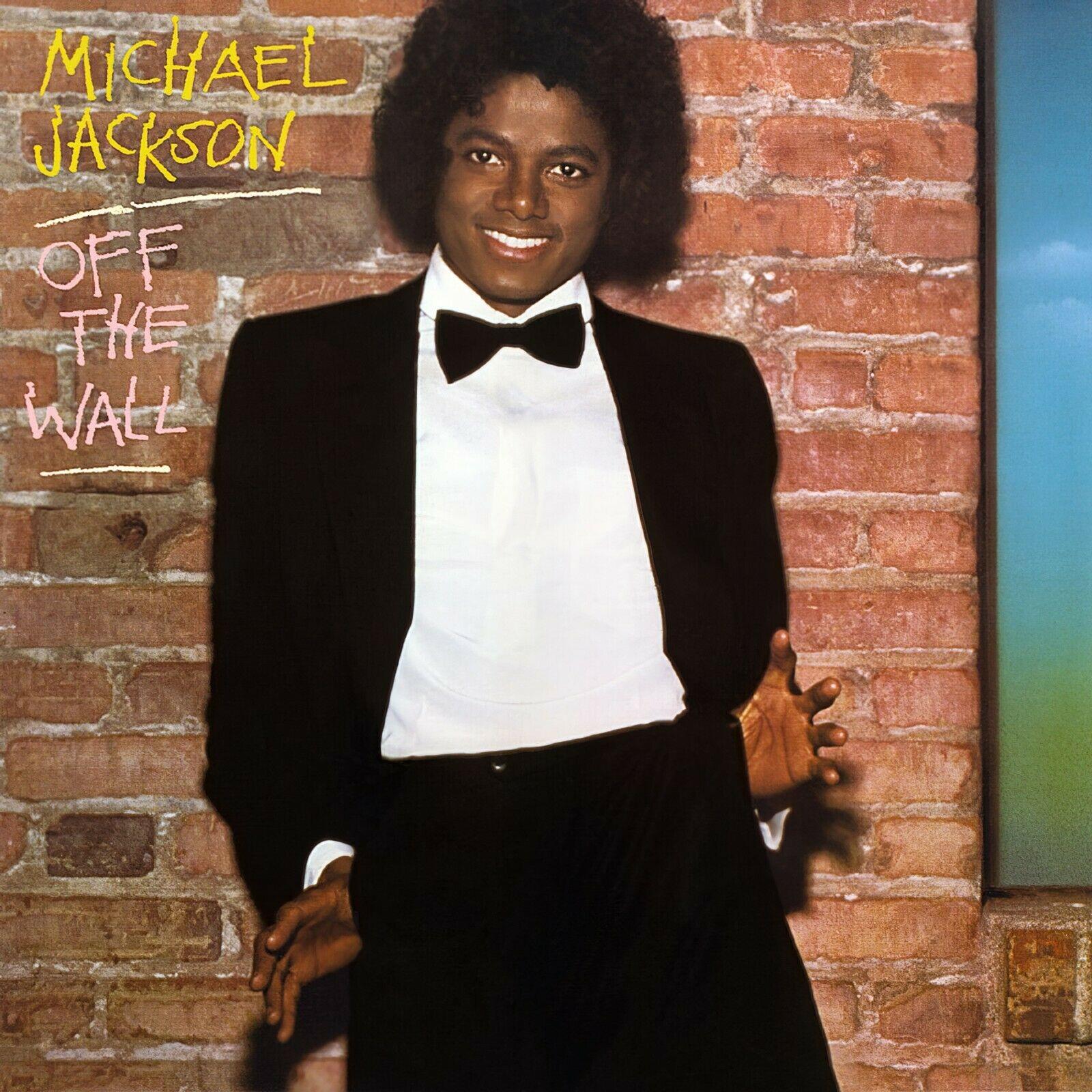 Michael Jackson radiates style and charisma in a striking portrait against a brick wall.