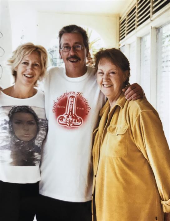 Friends pose together, smiling and enjoying each other's company in a bright, relaxed atmosphere.