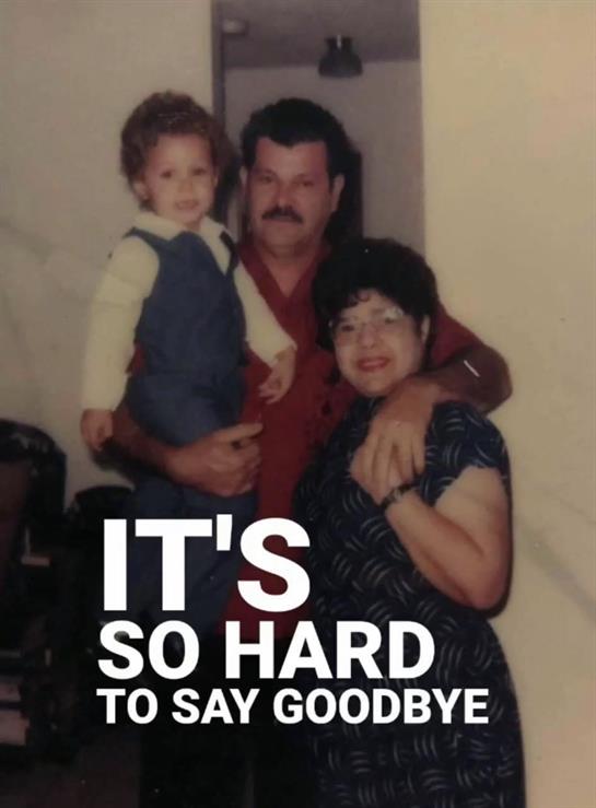 A child is held by a man while a woman embraces them both, marking a farewell moment.