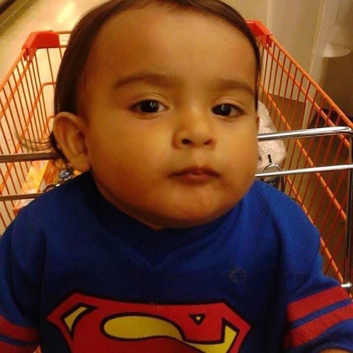 A baby in a shopping cart