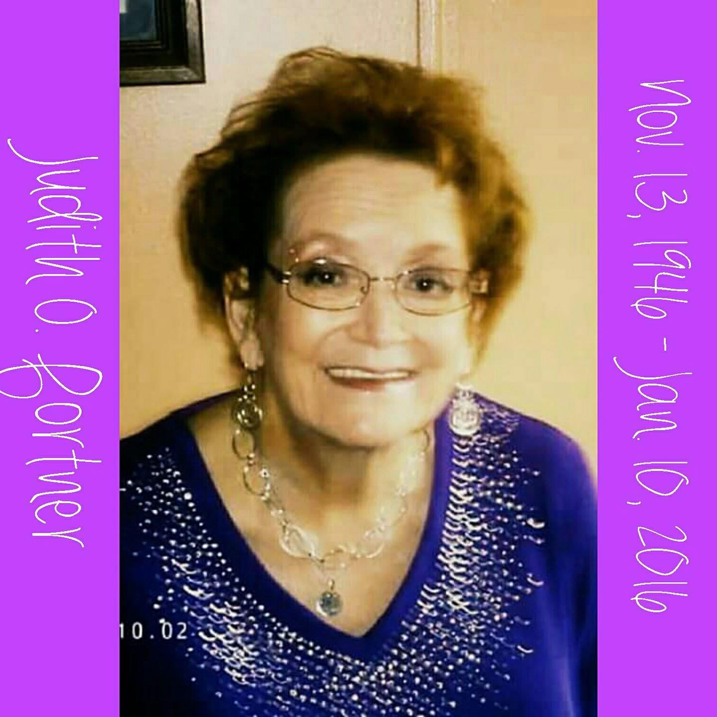 Judith O. Fortner smiles warmly while wearing a sparkling blue sweater, capturing a joyful moment.