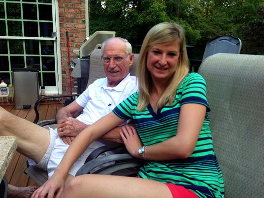 Two family members relax in garden chairs, enjoying a warm afternoon outdoors.