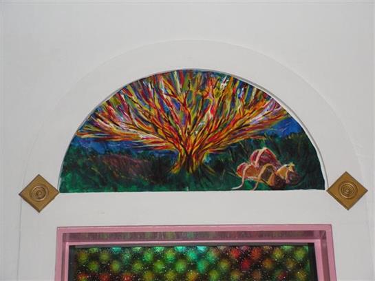 A vibrant coral reef design is displayed on a gallery wall, showcasing marine beauty.