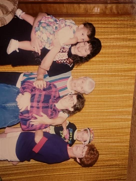 Family members share joyful moments together, showcasing love and connection in a warm atmosphere.