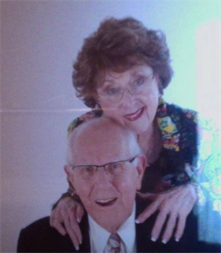 Couples enjoying a joyful moment during a family gathering, sharing smiles and affection.