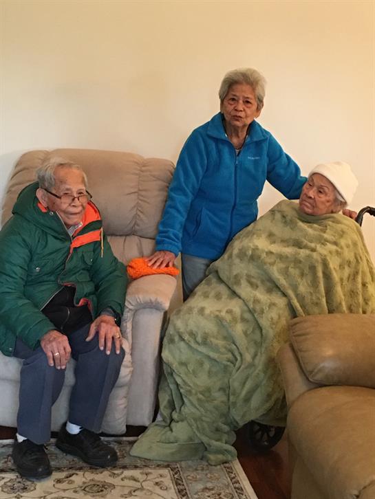 Family members spend quality time together, sharing warmth and stories in a cozy room.