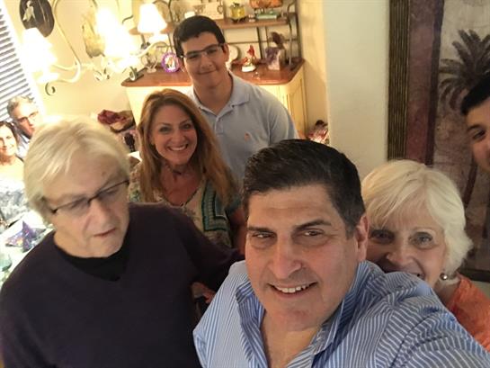 Relatives enjoying each other's company during a lively family gathering indoors.