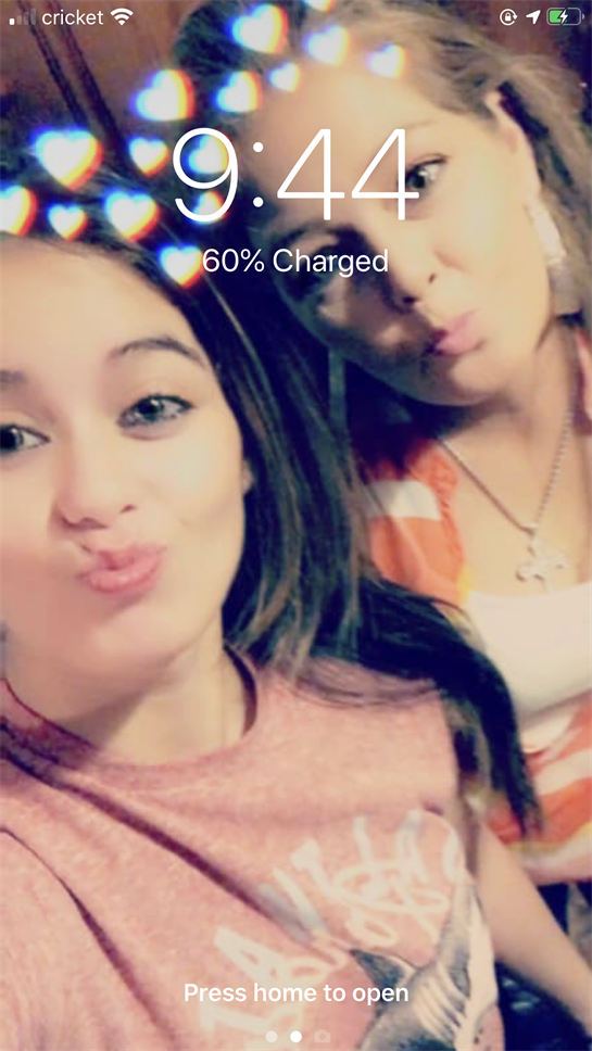 Two friends are taking a selfie with fun expressions and a playful atmosphere indoors.