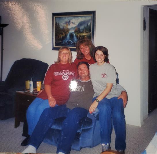 Friends sit together on a comfortable couch, enjoying each other's company in a relaxed atmosphere.