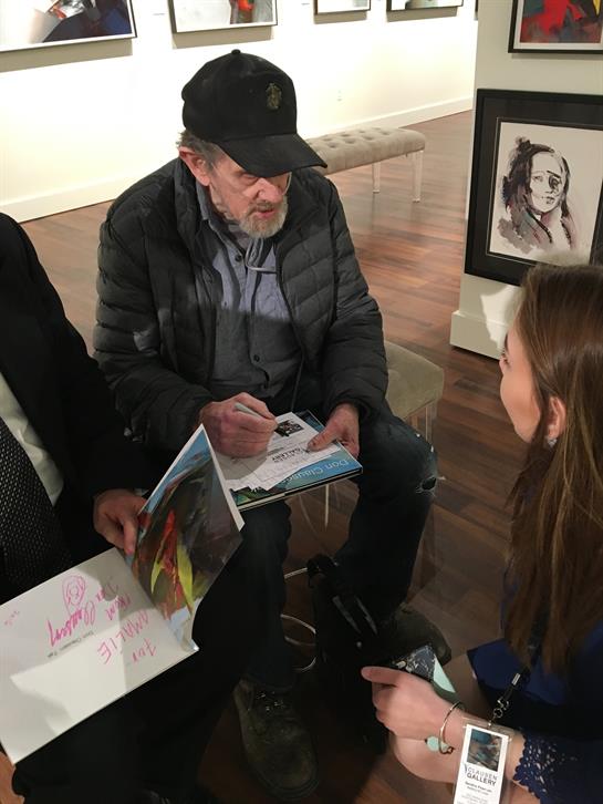 Attendees gather at an art gallery for a fun celebrity signing event and memorable moments.