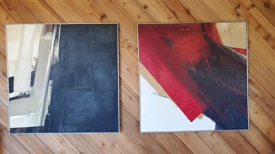 Two abstract artworks on a wooden floor highlight bold colors and intricate designs.