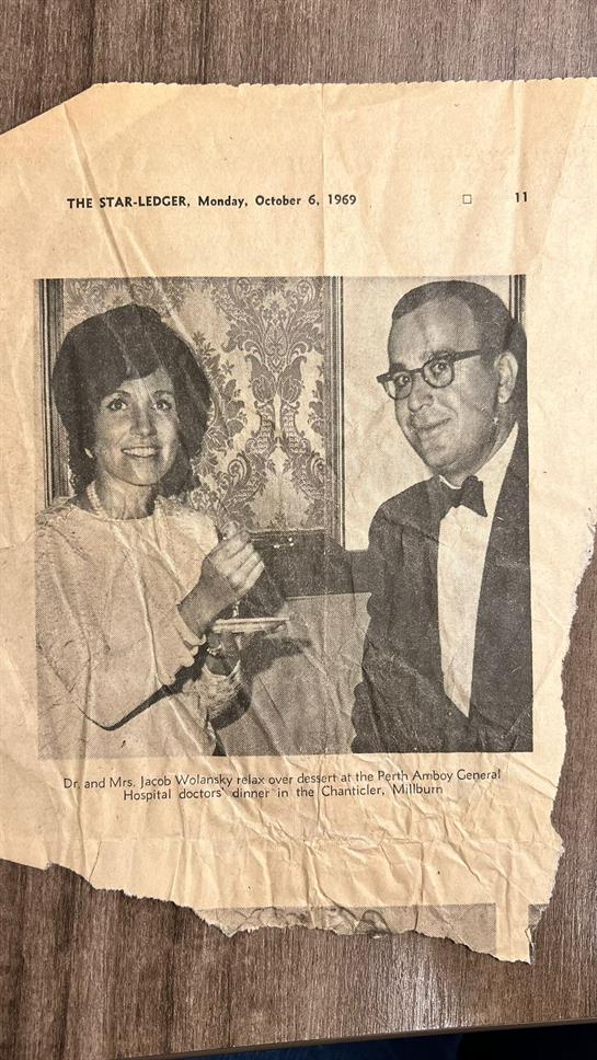 Stylish couple engaged in conversation at a formal dinner event in Charlevoix, Michigan.