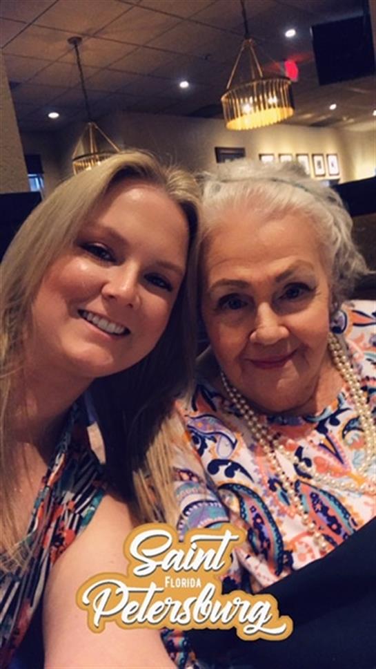 Two generations share smiles and laughter while enjoying each other's company at dinner.