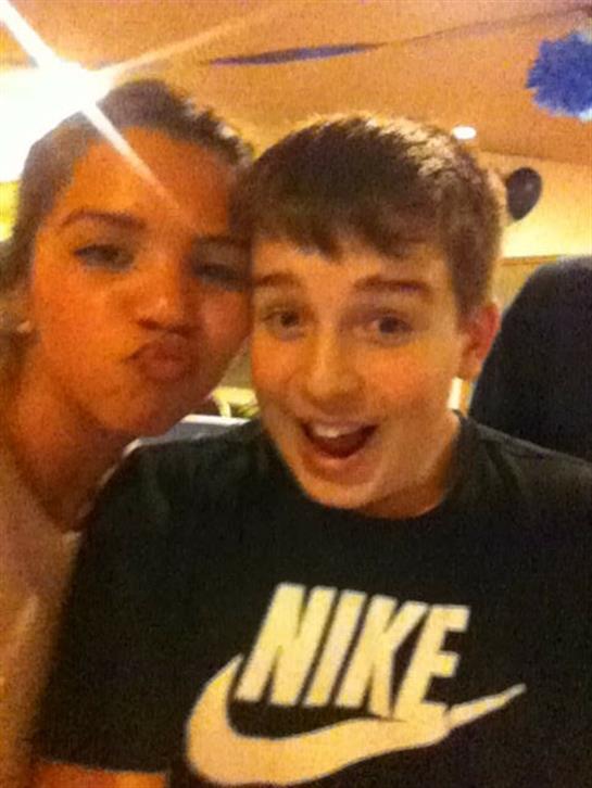 Two teens have fun together, showing playful expressions in a relaxed setting.