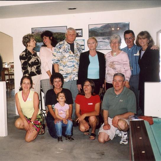 Group of family members posing together in a coastal home, sharing joyful moments indoors.
