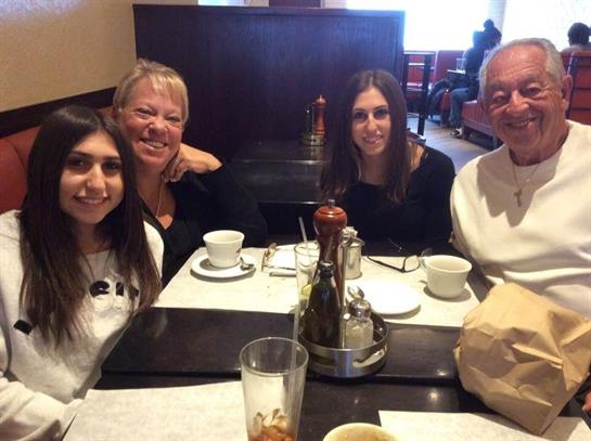 Four friends enjoy brunch together at a cozy cafe, sharing smiles and good food.