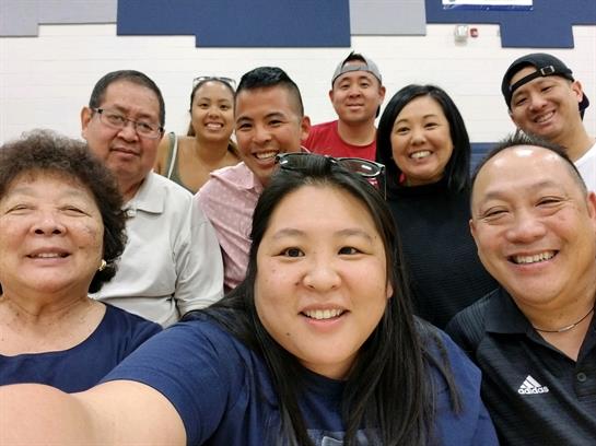 Friends gather in a gymnasium to capture a lively selfie filled with smiles and laughter.
