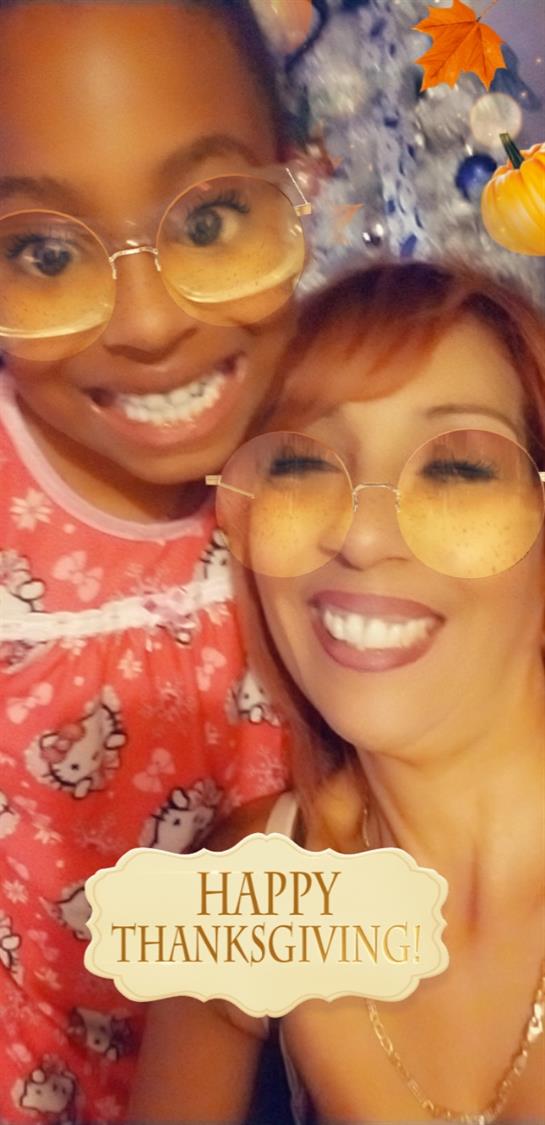 Two people in playful outfits and matching glasses smile, showcasing joy and connection.