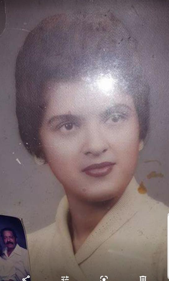 This vintage portrait captures a young woman with a classic hairstyle, evoking nostalgia.