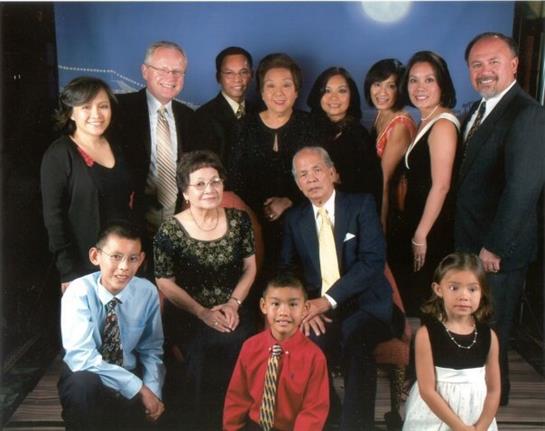 A large family comes together for a formal occasion, showcasing unity and love in celebration.