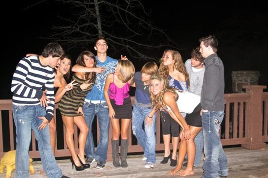 Friends gather on a balcony for a lively night filled with laughter and fun activities.