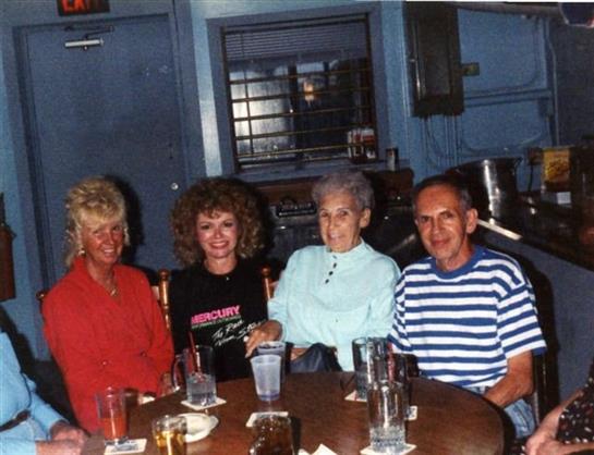 Group of friends relaxing at a bar, sharing stories and laughter while enjoying their drinks.