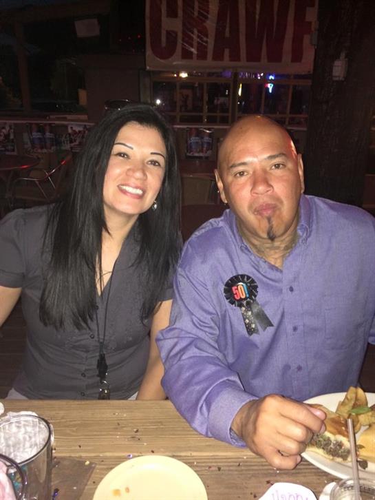Two friends share a joyful dinner, smiling and enjoying their time together.