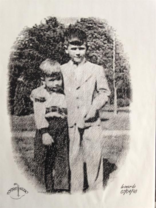 Two young boys in early 20th-century attire pose together in a park.