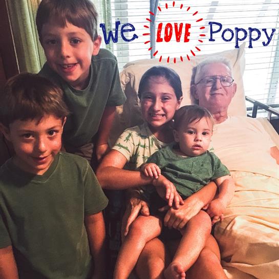 Children pose joyfully with their beloved grandfather, expressing affection and family bonds.