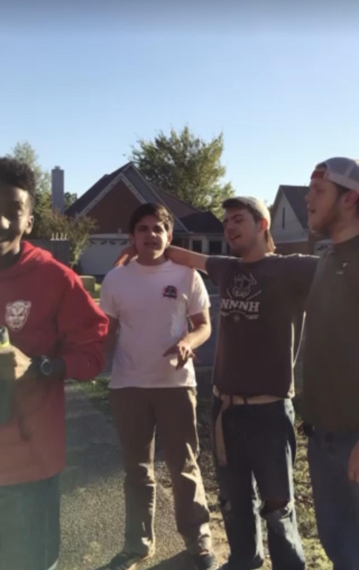 A group of men standing in a yard