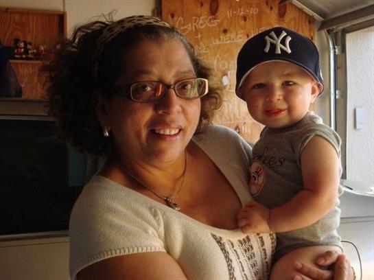 Warm moment shared between a grandmother and her joyful grandson at a family gathering.