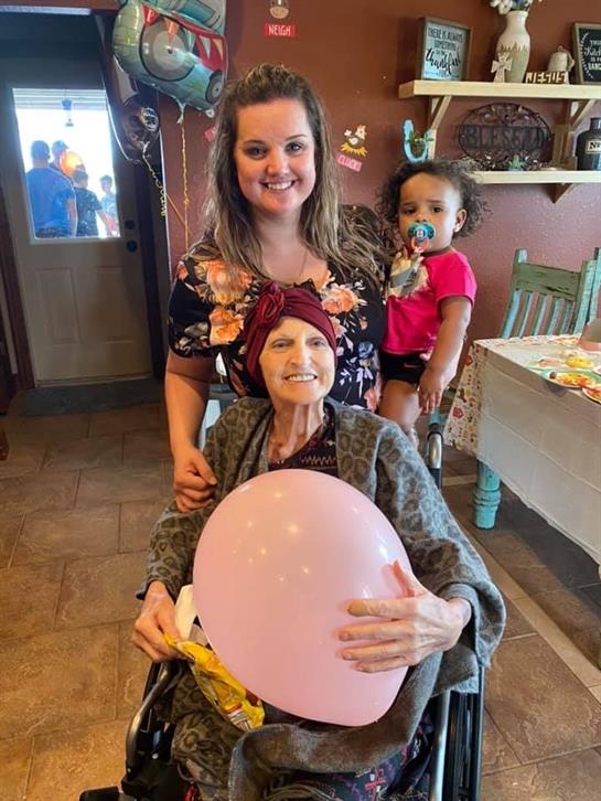 Family members gather to celebrate, sharing joy while a child holds onto a colorful balloon.