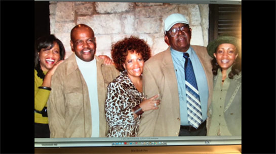 Friends gather, smiling in stylish outfits, showing camaraderie at a celebration.