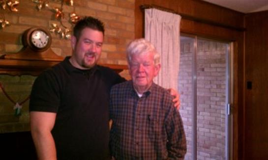 Two men share a warm moment in a home, showcasing their bond and the joy of family connections.