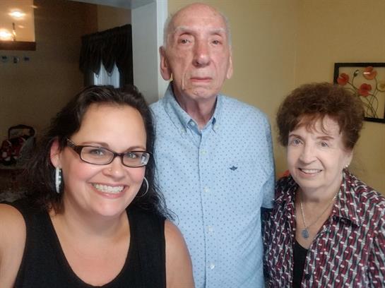 Happy family members smile together, capturing a warm moment in a comfortable indoor space.