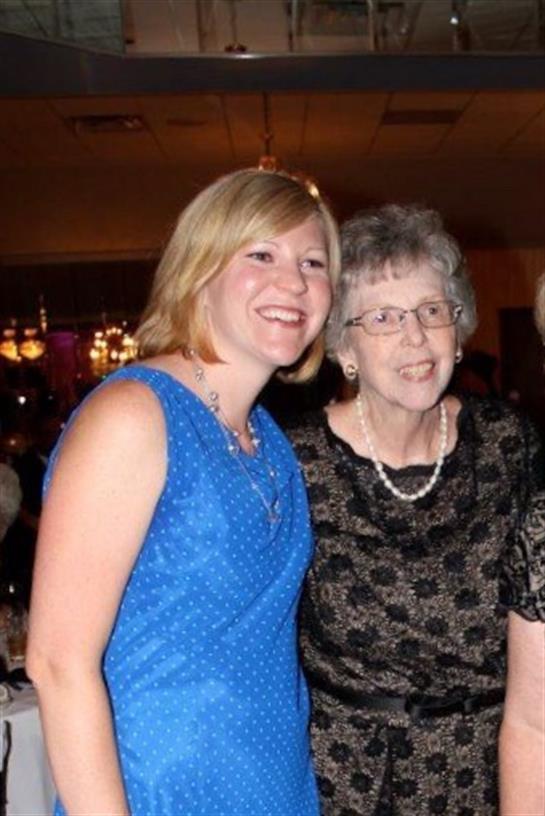 A joyful gathering featuring two generations celebrating together in elegant attire.