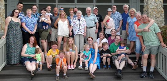Families gather on the steps, celebrating together in the warm weather.