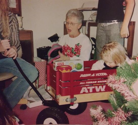 Adults and kids celebrate together in a cozy, festive living room.